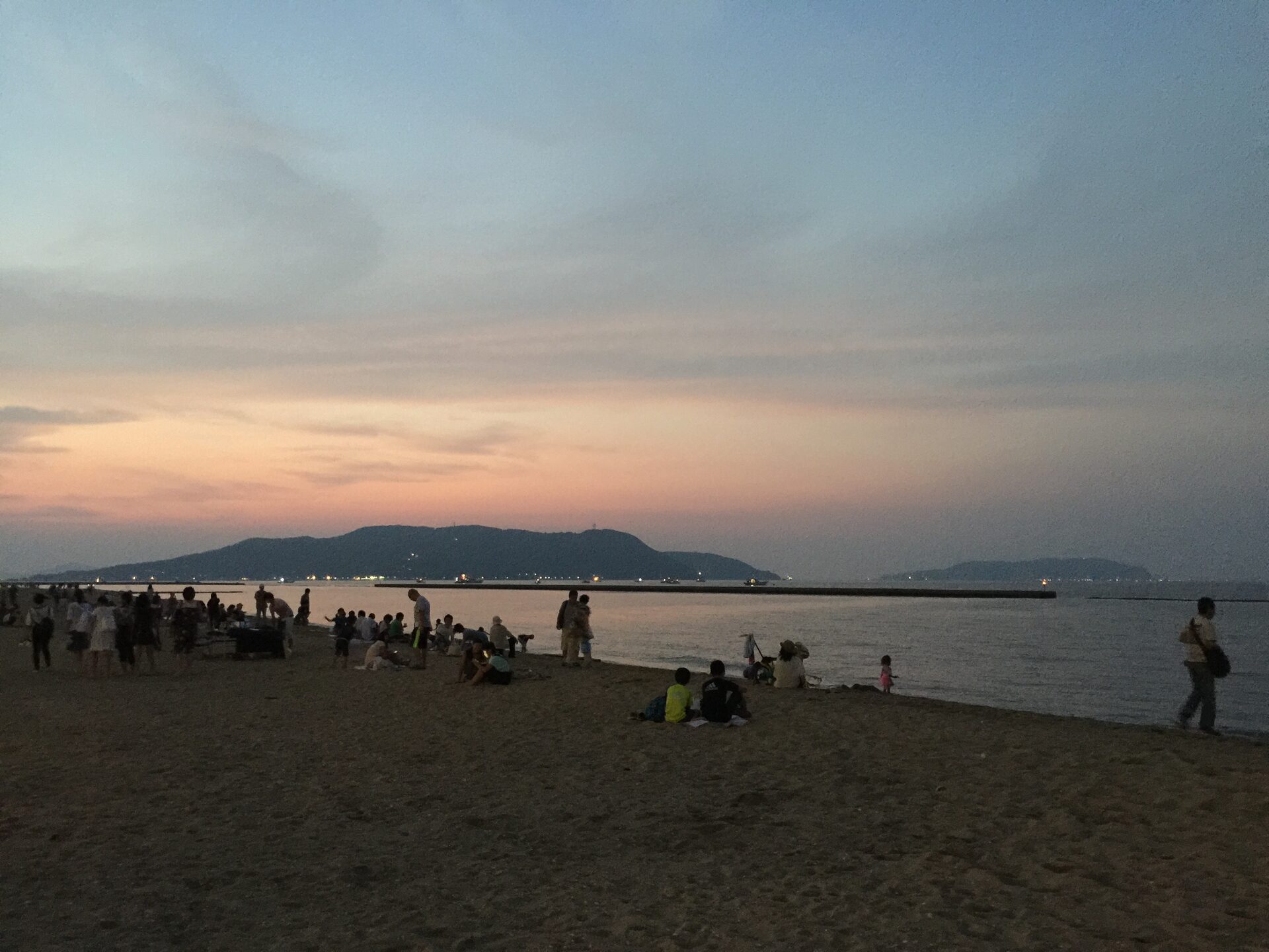 Beach at sunset with people enjoying the evening